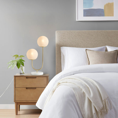 Modern metal two-light globe table lamp on bedside console — view 2