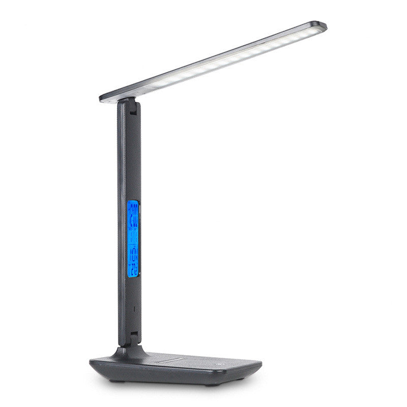 LED desk lamp with wireless charging pad and USB port
