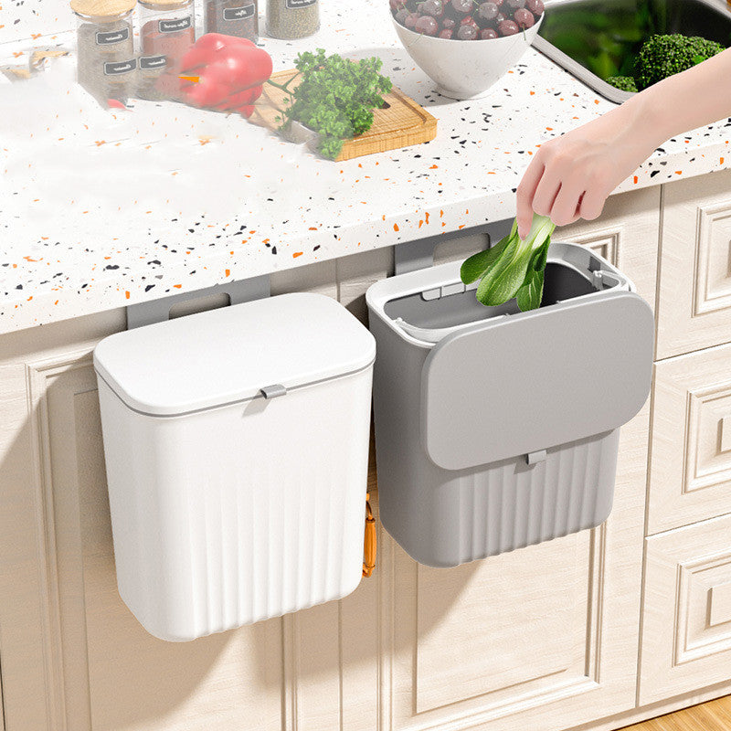 Hanging kitchen waste bin with lid mounted on cabinet door