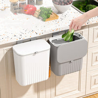 Hanging kitchen waste bin with lid mounted on cabinet door